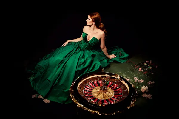 A woman in a luxurious green gown next to an ornate roulette wheel, capturing the upscale casino mood of KG999.