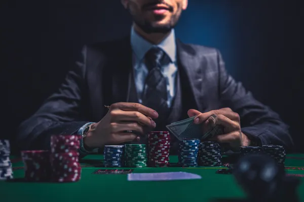 A confident dealer surrounded by casino chips inviting players to access their KG999 account, reflecting quick and easy login options.
